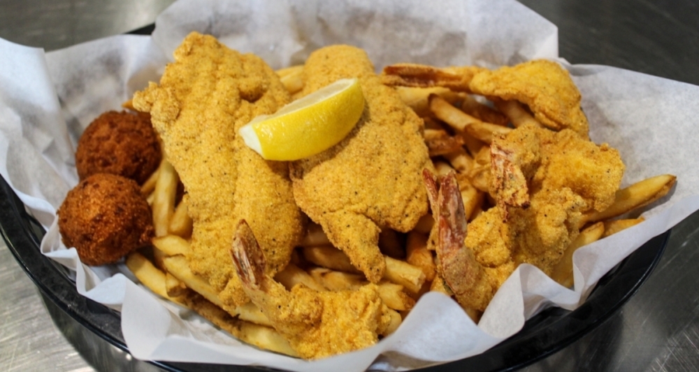 Chief operating partner Bill Curci said Shuck Me’s most popular food item is its fried catfish, which can be served alone or as part of a combo with shrimp or oysters. (Bailey Lewis/Community Impact Newspaper)