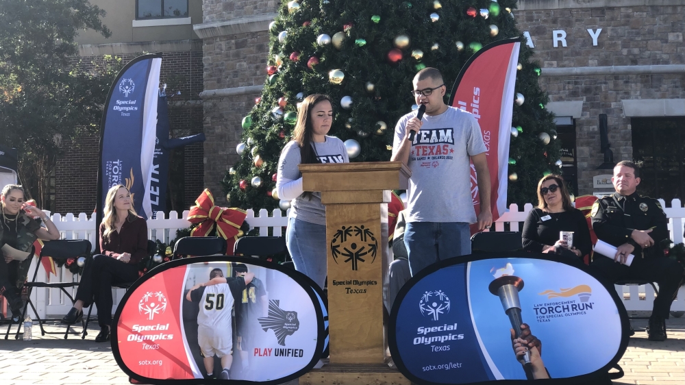 Special Olympics athlete Benji Garcia speaks to the crowd with his Special Olympics Unified partner Mady Zamora during the Winter Games 2022 press conference. (Grace Dickens/Community Impact Newspaper)