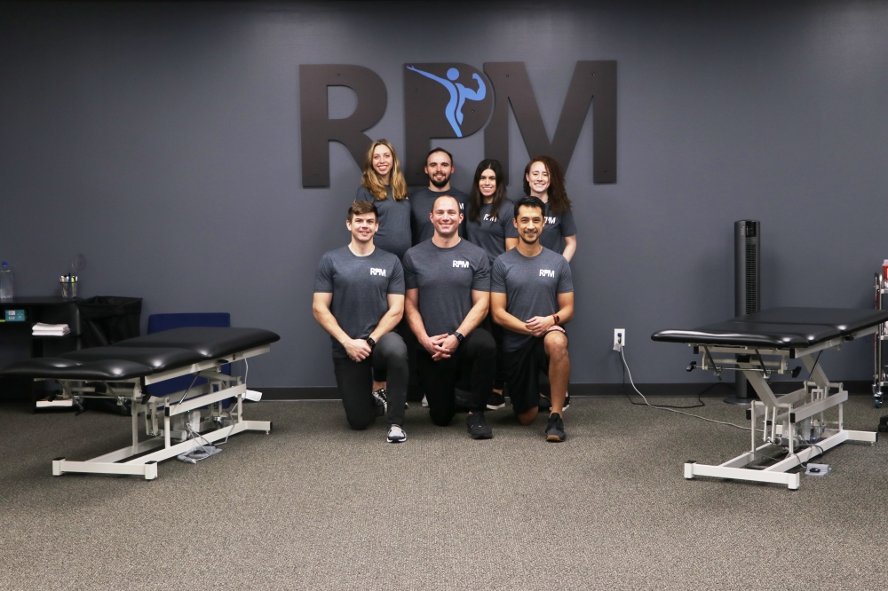 Dr. Jonathan Ruzicka (front row, center) works with a team of physical therapists and trainers at RPM Physical Therapy. (Courtesy RPM Physical Therapy)