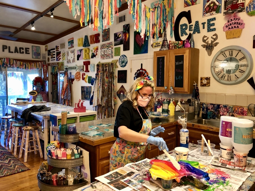 Art Barn ATX owner Amber Gordon uses resin on a project. (Community Impact Newspaper staff)