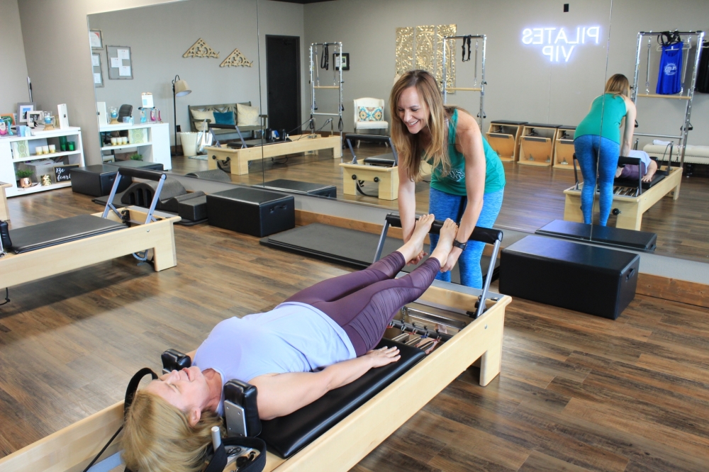 Valerie Lucas, owner of Pilates VIP in Fort Worth, demonstrates exercises on the reformer, one of the machines used in Pilates. (Sandra Sadek/Community Impact Newspaper)