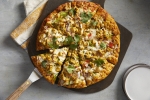 Curry Pizza House's curry chicken masala pizza includes a curry sauce, cheese, bell peppers, red onion, diced tomato, masala chicken and cilantro. (Courtesy Curry Pizza House)