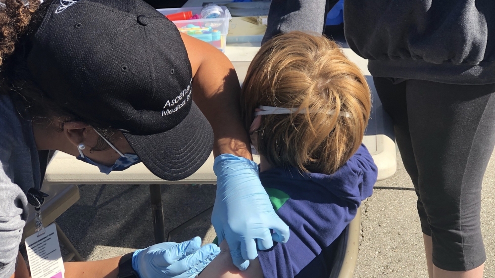 Photo of child receiving COVID-19 vaccination
