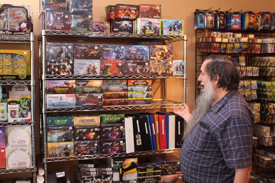 Owner Robert Parish stocks popular card decks for his customers. (Dave Manning/Community Impact)