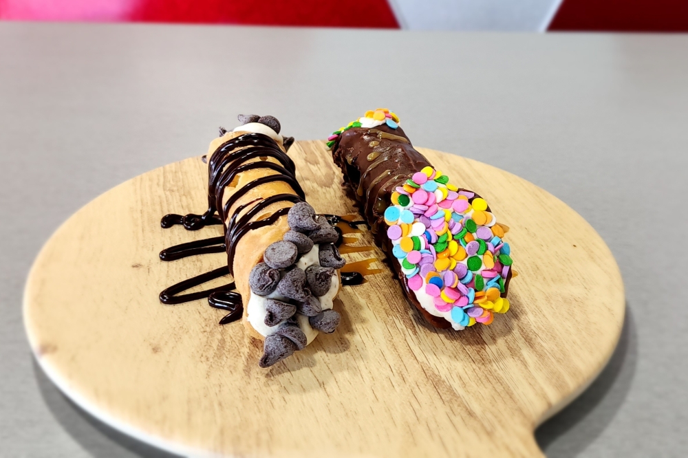 Cannolis topped with chocolate. 