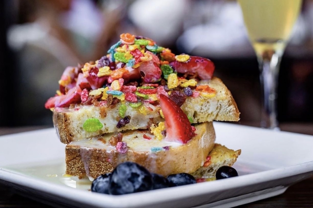 Fruity Pebble French Toast includes cereal, condensed milk glaze, and fresh berries.  (Courtesy of Bosscat Kitchen & Libations)