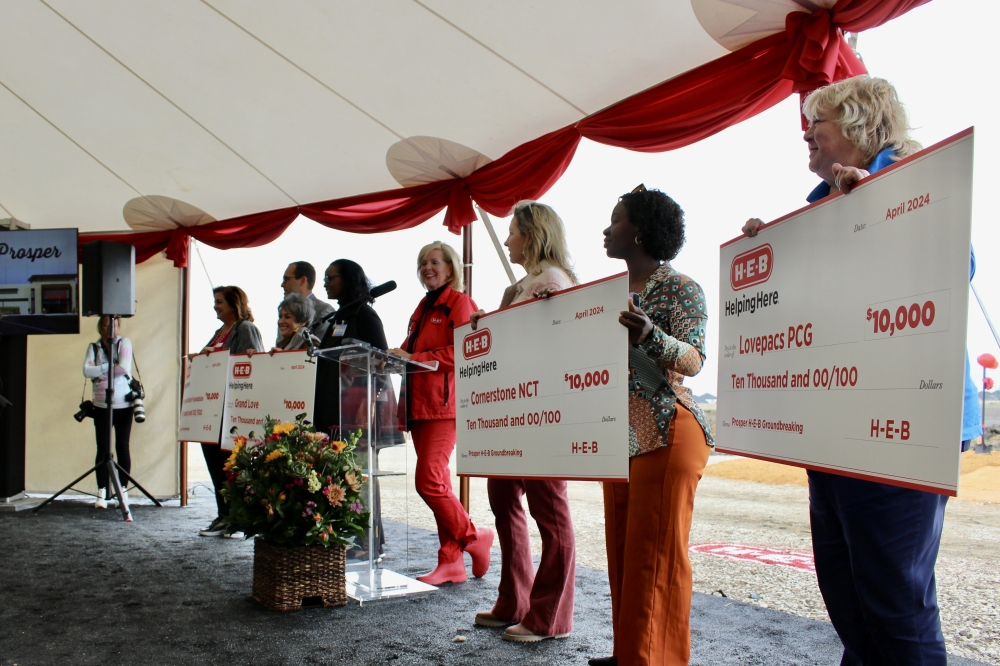 Representatives for four local groups received a check for $10,000 during the groundbreaking ceremony. (Alex Reece/Community Impact) 