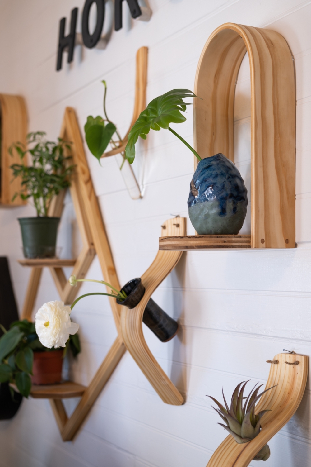 Horsemen Co. offers handcrafted bent-wood plant hangers, ceramic and wooden art pieces, and a variety of plants. (Courtesy Faith Benitez)