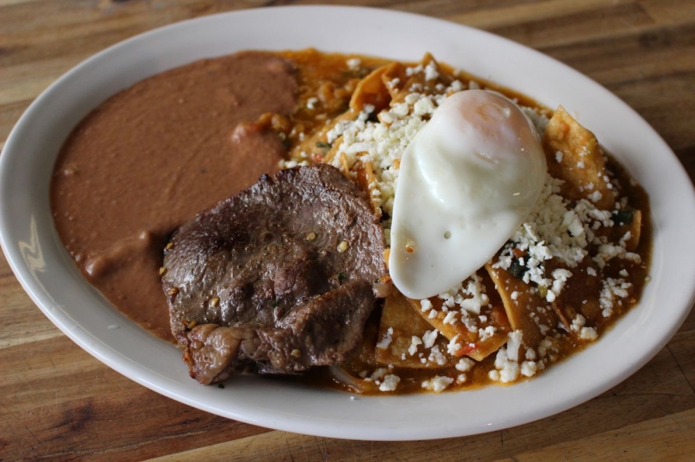 Chilaquiles are a traditional Mexican breakfast dish consisting of corn tortillas that are lightly fried, then coated in a salsa and topped with an egg and choice of protein. (Asia Armour/Community Impact)