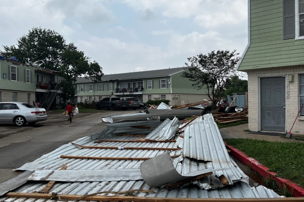 Pieces of a damaged apartment complex in northwest Houston lay over the parking spaces while residents have been without power since May 16, according to county officials. (Melissa Enaje/Community Impact)