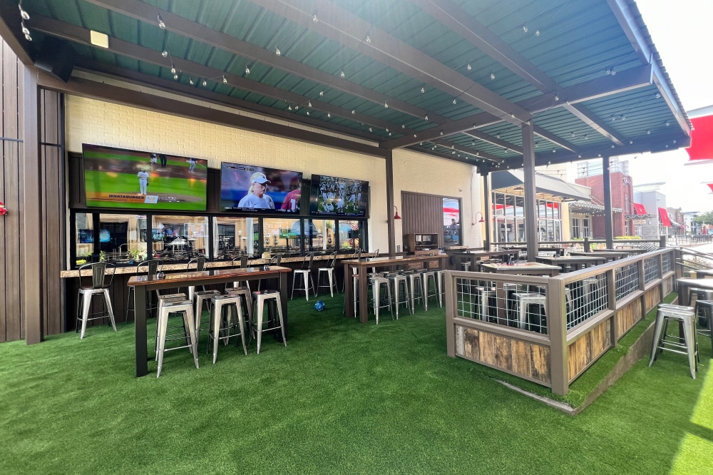 The icehouse features more than 50 beers on tap, wine, cocktails, and a dog-friendly outdoor patio with a 300-inch TV. (Courtesy Little Woodrow's)
