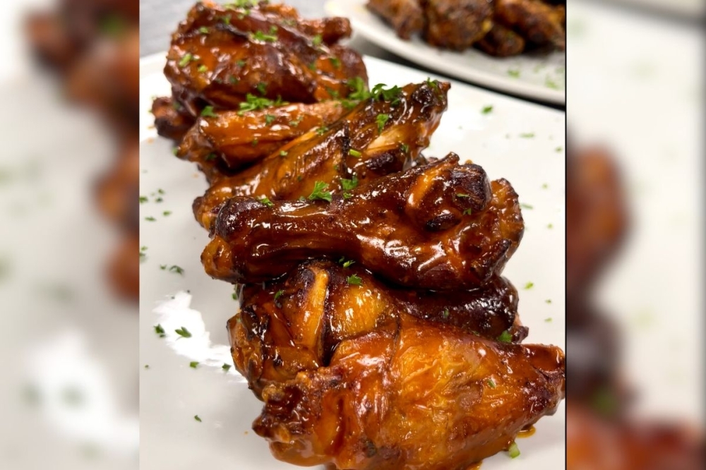 The restaurant and bar highlights its wings, which are smoked, fried and tossed in one of many specialty sauces. (Courtesy Playbook Sports Bar & Grill)