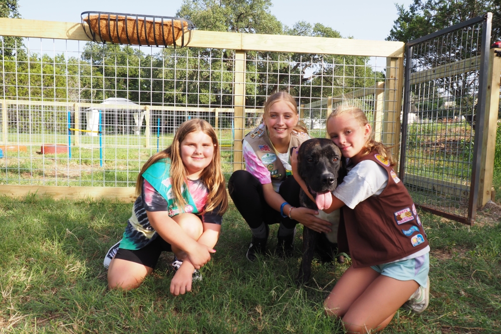 Photo of the Girl Scout troop with a shelter dog named Patches.