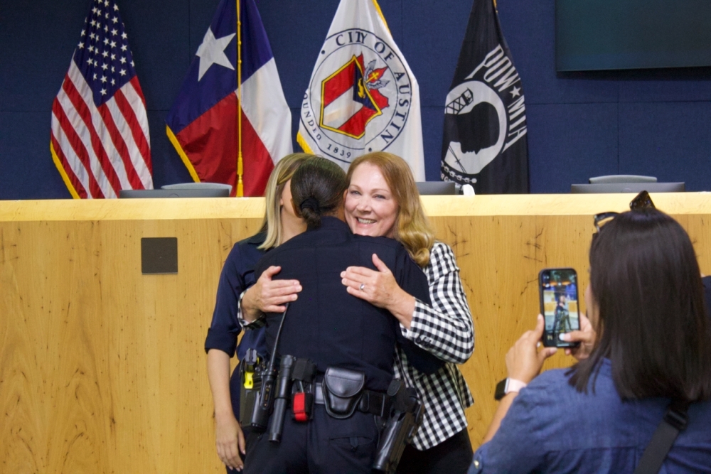 Davis embraced interim Police Chief Robin Henderson after her confirmation. (Ben Thompson/Community Impact)