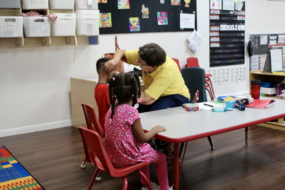 Sandy Martin performed a 30 second hearing exam to children f Children's Lighthouse of Houston on Sept. 12. (Jovanna Aguilar/Community Impact)