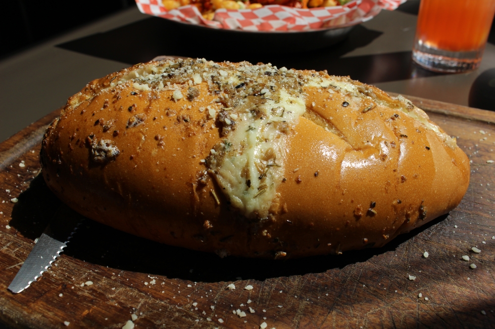 Dak & Bop's garlic bread is made with herb cream, mascarpone, garlic butter and grated parmesan. (Asia Armour/Community Impact)