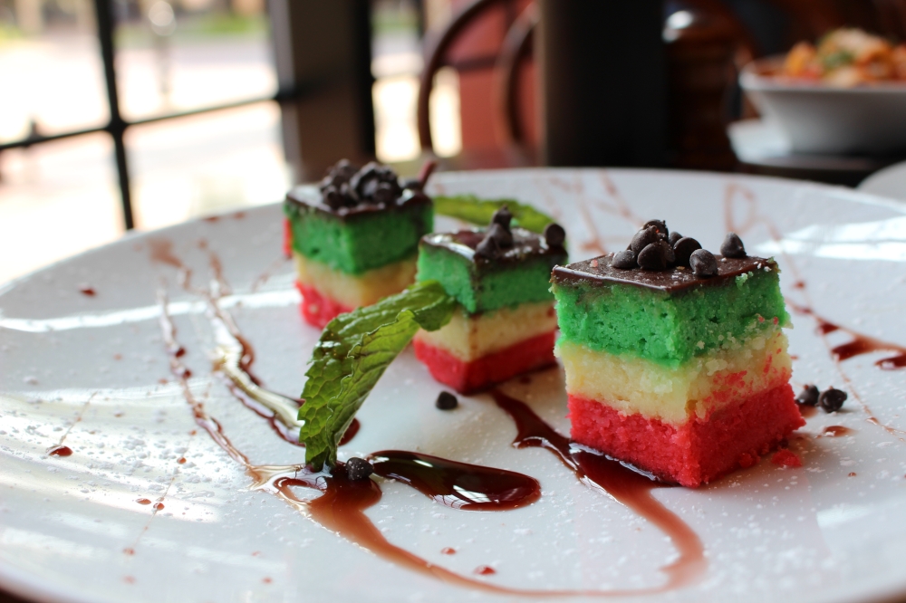 Chef Bruno Amato developed a multi-layered, Italian flag colored almond cake dessert with raspberry simple syrup, chocolate chips and cherries in the spring. (Asia Armour/Community Impact)