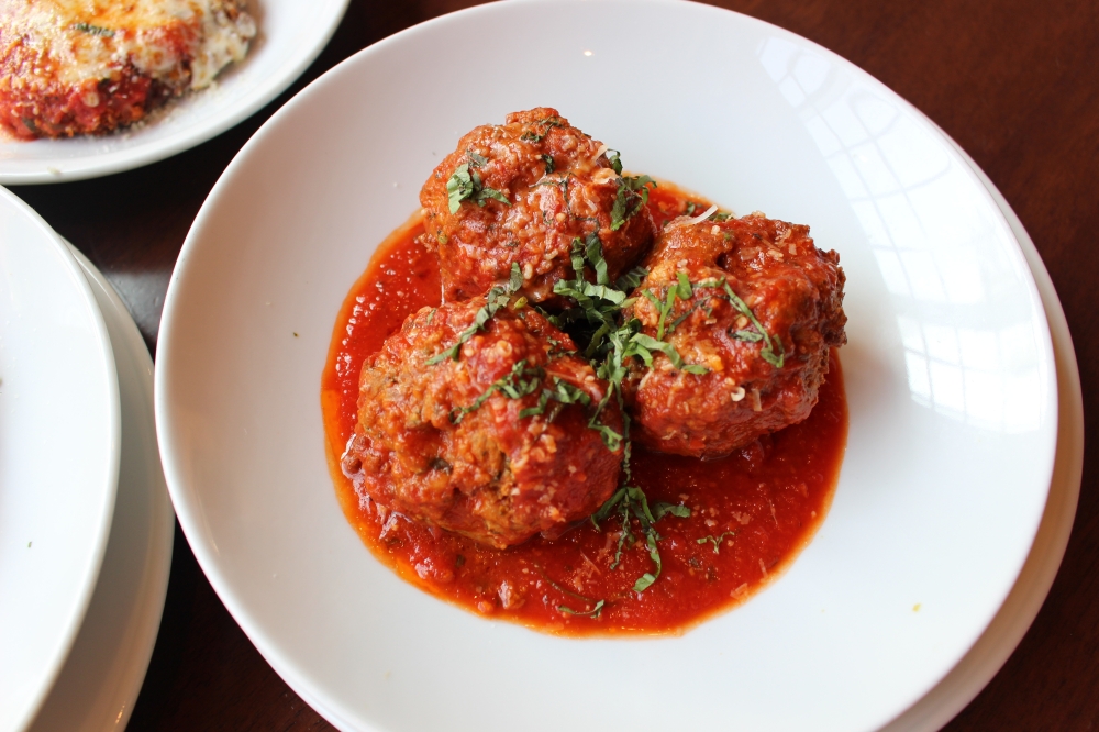 The pork and beef meatball appetizer ($15) is topped with pomodoro and parmesan. (Asia Armour/Community Impact)