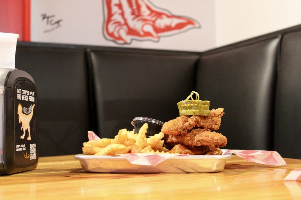 Mother Cluckers ($14.99) includes four Nashville hot chicken tenders, french fries, Coop sauce, toast and pickles. (Jovanna Aguilar/Community Impact)