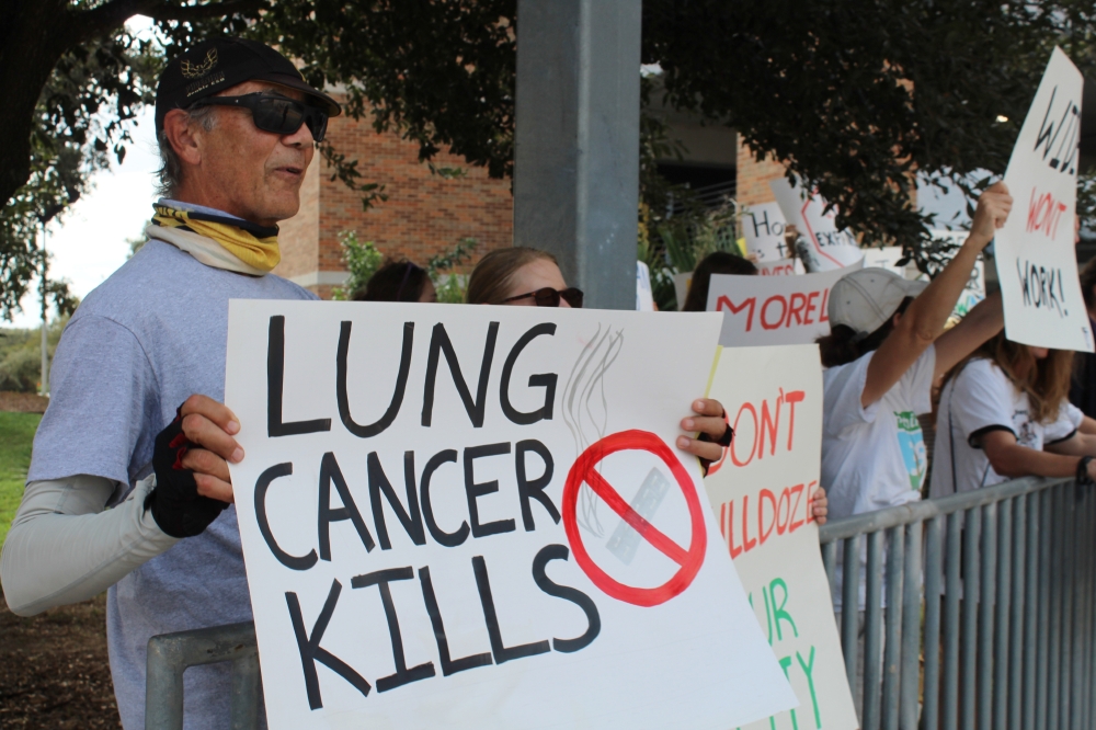 Members with Rethink35 protested the Texas Department of Transportation groundbreaking of construction on I-35 in central Austin, stating that local air pollution will increase with a highway expansion. (Haley McLeod/Community Impact)