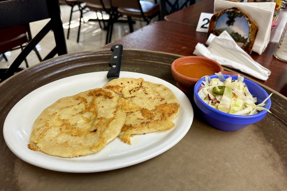 The pupusas ($2.99 each) can be ordered with chicharron, beans, cheese or loroco. It comes with a side of pickled slaw and red salsa. (Thalia Guzman/Community Impact)