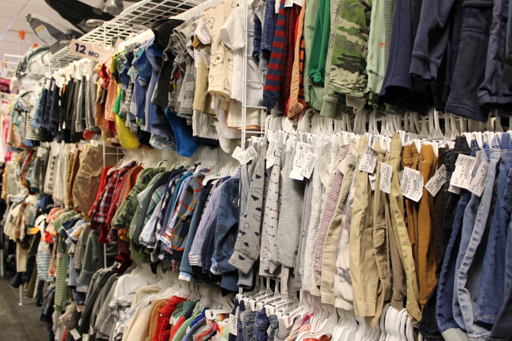 Inside the store, racks of children's clothing are organized by size. (Anna Maness/Community Impact) 