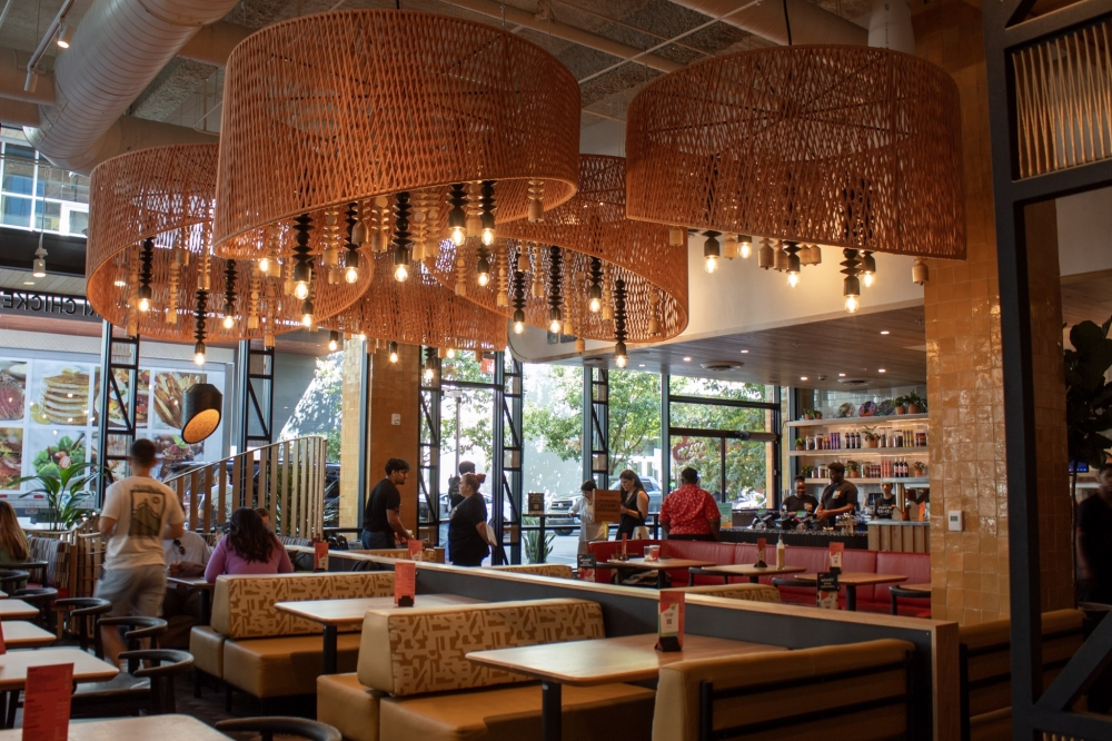 The interior of Nando's was designed by Austin-based architect Michael Hsu and features pieces from South African artisans. (Elisabeth Jimenez/Community Impact)