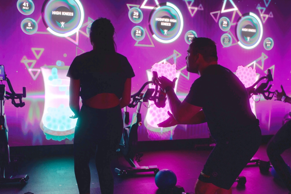 Classes are led by an artificial intelligence trainer who take clients through high intensity functional training, while an in-person coach supports and provides members additional feedback as needed. (Courtesy Lumin Fitness)