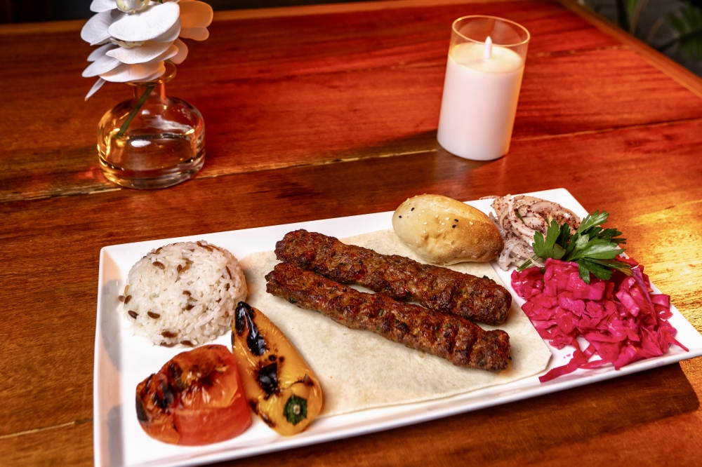 Adana Kebab ($18.45) is made with a mixture of beef and lamb mince, grilled tomatoes, peppers, sumac onions, purple cabbage, parsley and bulgur.(Courtesy Yucca Grill)