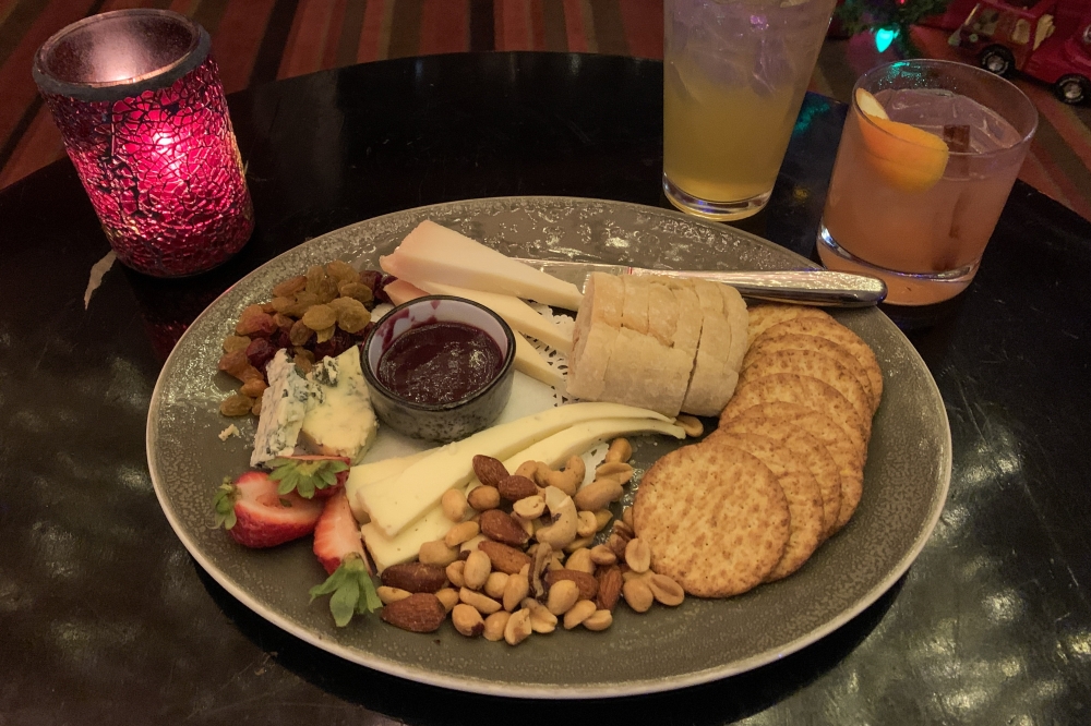 The bar menu offers appetizers such as a cheese board which includes, bread, crackers, a variety of nuts, fresh and dried fruits, aged goat milk cheese, moutonzola blue cheese and black truffle caciotta. (Elisabeth Jimenez/Community Impact)