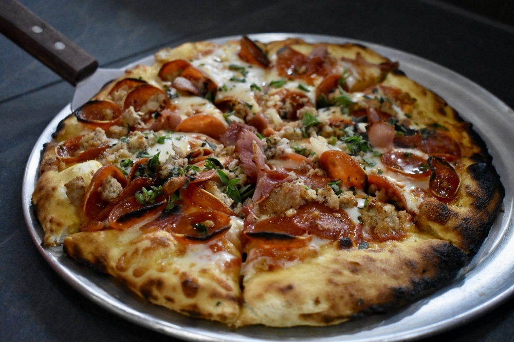 The Amanti Della Carne ($18) is made with tomato sauce, mozzarella, prosciutto, homemade fennel sausage, cup-and-char pepperoni and oregano. (Courtesy Sylvia’s Pizza)