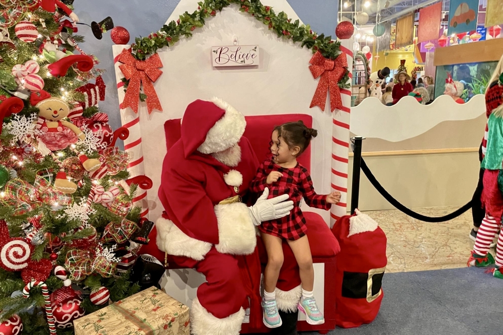 At the Santa's Merry Mingle attendees can get a framed professional photo with Santa. (Courtesy The Woodlands Children’s Museum)