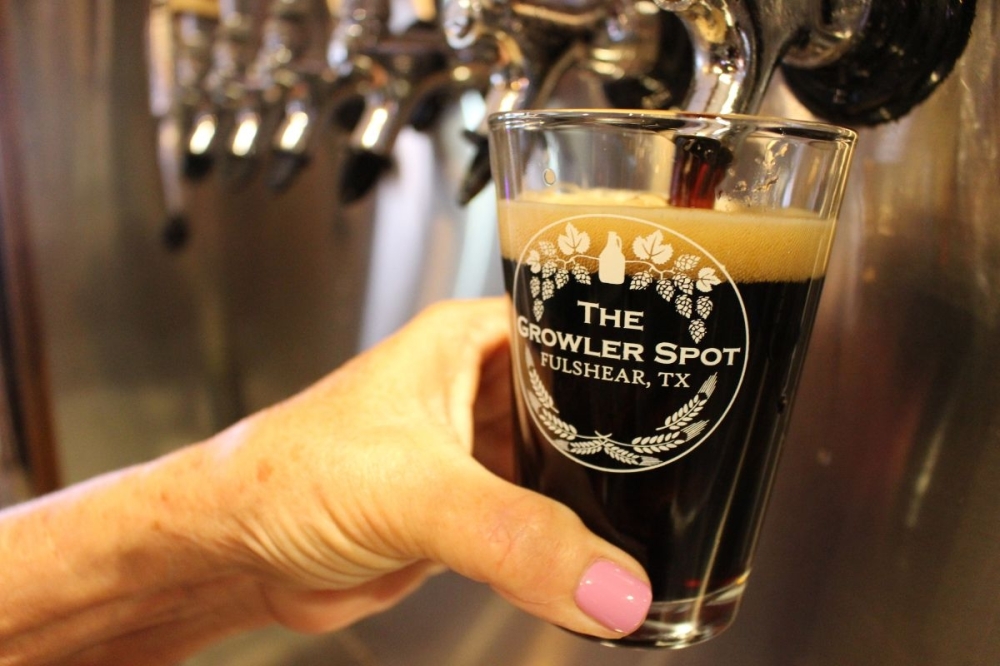 The Growler Spot rotates 40 craft beer taps and has 12 local wines available. (Asia Armour/Community Impact)