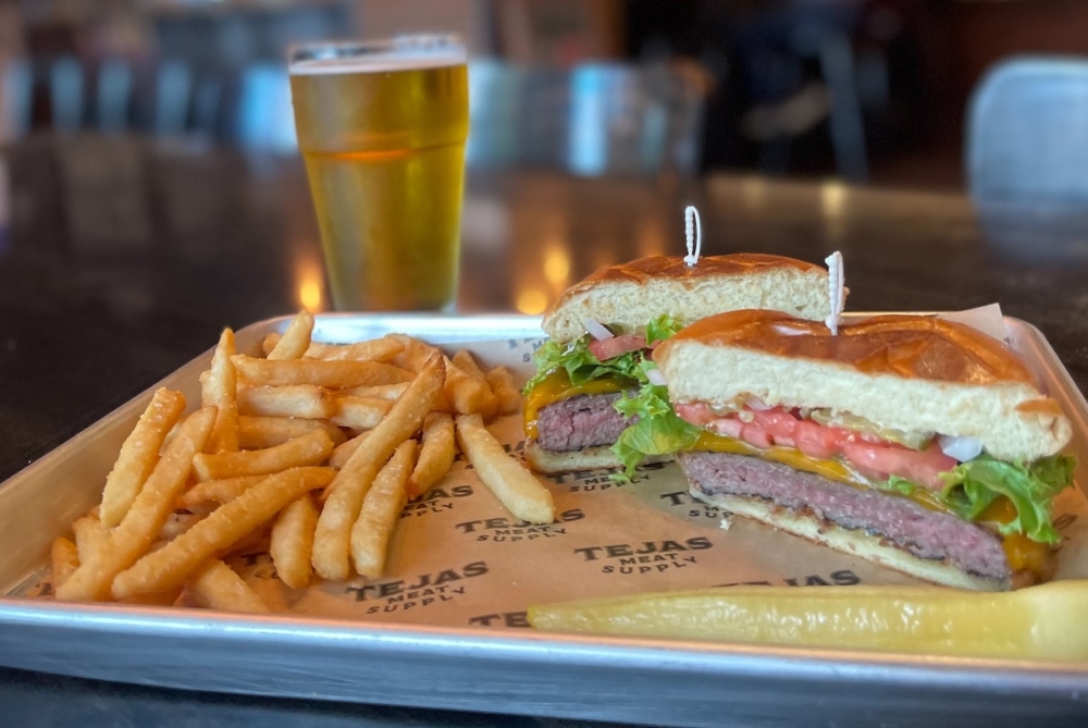 The single patty burger ($13.95) is a blend of brisket, chuck and short rib. Customers can add an assortment of cheese, vegetables and sauces. (Courtesy Tejas Meat Supply)