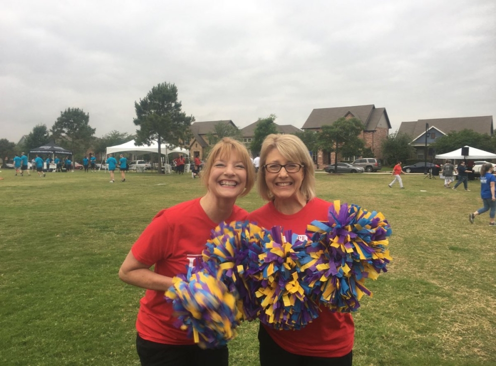 Cy-Hope Executive Director Lynda Dierker (left) and former Finance Director Holly Calbat (right) cheer with Cy-Fair ISD pom poms at an event. (Courtesy Lynda Dierker)