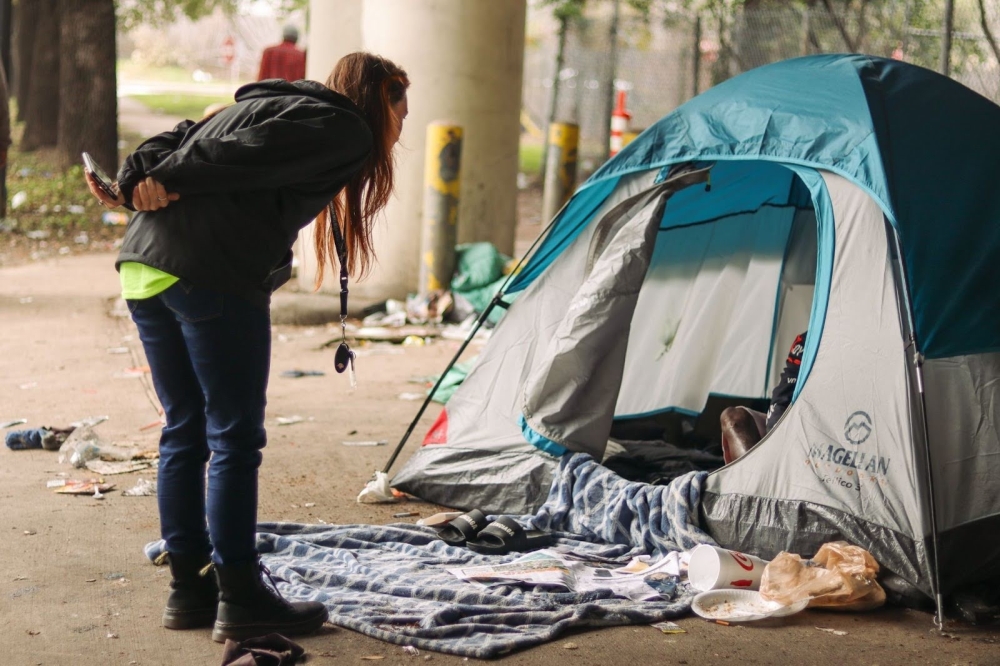 Coalition for the Homeless Outreach staff tend to a homeless individual, gathering information for the 2023 point-in-time count. (Courtesy Coalition for the Homeless)