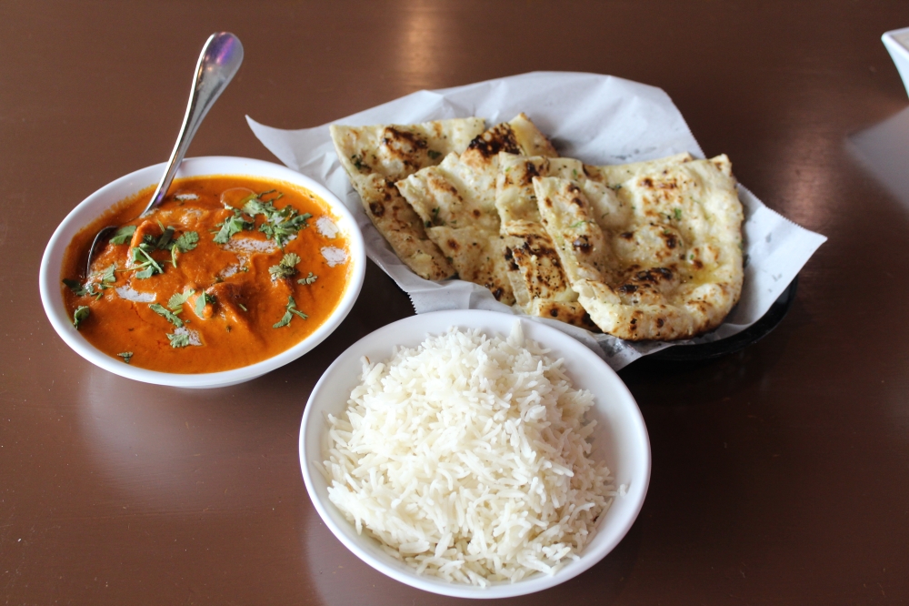 The butter chicken ($17.49) with garlic naan ($4.99) is a customer favorite. (Sarah Hernandez/Community Impact)