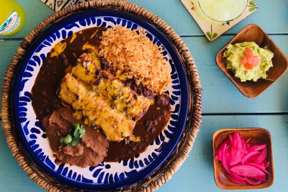 Cruzteca's enchiladas ($15.99-$16.99) are topped with Austin-style chili beef sauce and cheese. (Courtesy Cruzteca)