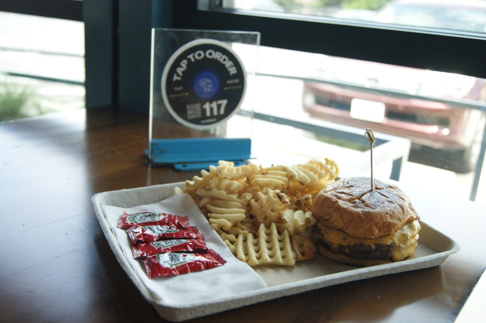 The CM classic cheeseburger at Bouldin Acres has two quarter pound patties, American cheese, pickles and dijonnaise for $17. (Dacia Garcia/Community Impact)