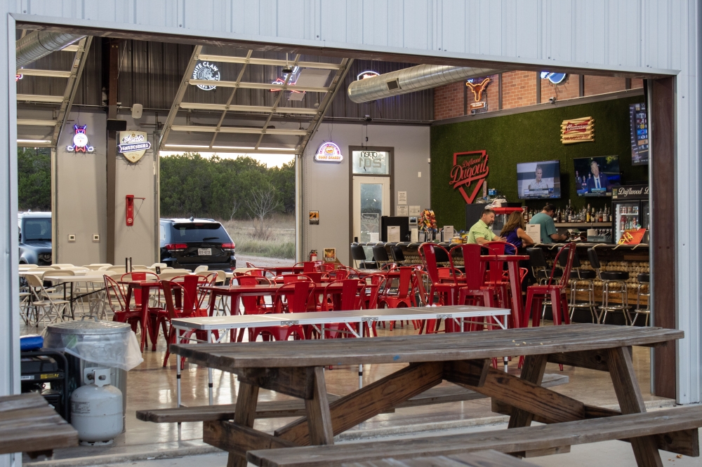 Guests at Driftwood Axe House can enjoy other activities and services at the establishment, such as an open dining space, a bar with flatscreen TVs, a beer pong table and other amenities. (Elisabeth Jimenez/Community Impact)