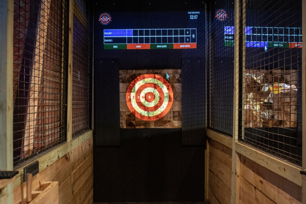 Guests can use the lanes for traditional target practice or play mini games at Driftwood Axe House, such as “shooting” ducks with the axe or practice ax-throwing by playing word games. (Elisabeth Jimenez/Community Impact)