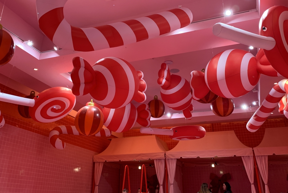 The Museum of Ice Cream decorated from top to bottom to create its Pinkmas holiday event running through Jan. 20, including candy canes floating from the ceiling and large ribbons on the walls near the sprinkle pool. (Elisabeth Jimenez/Community Impact)