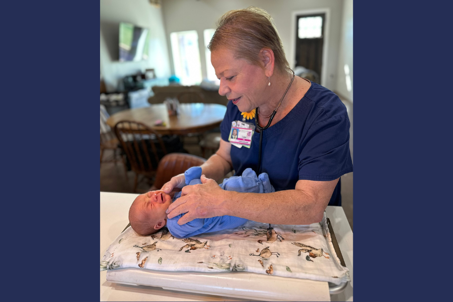 Labor and delivery doctor holds a baby