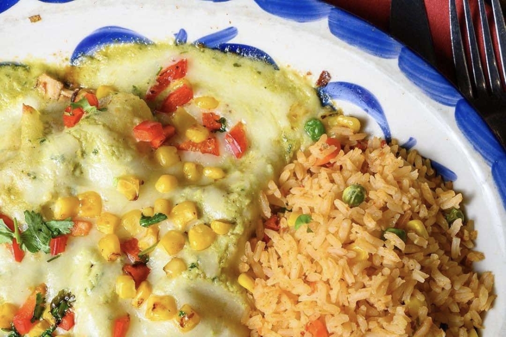 The enchiladas verdes ($17.95) is a restaurant staple and includes three beef or chicken enchiladas topped with our fire roasted tomatillo sauce and monterey cheese. (Courtesy Juanita's Mexican Kitchen)