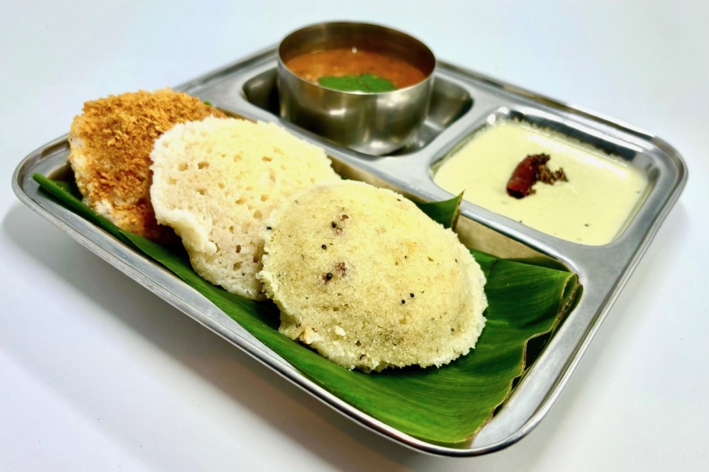 Idly are steamed rice cakes served with lentils and coconut and tomato chutneys. (Courtesy Gayatri Bhavan)