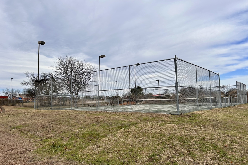 The new potential skatepark in Gregg-Clarke park is going to be built over the current tennis court, which is in need of repair. (Jamie Moore/Community Impact)