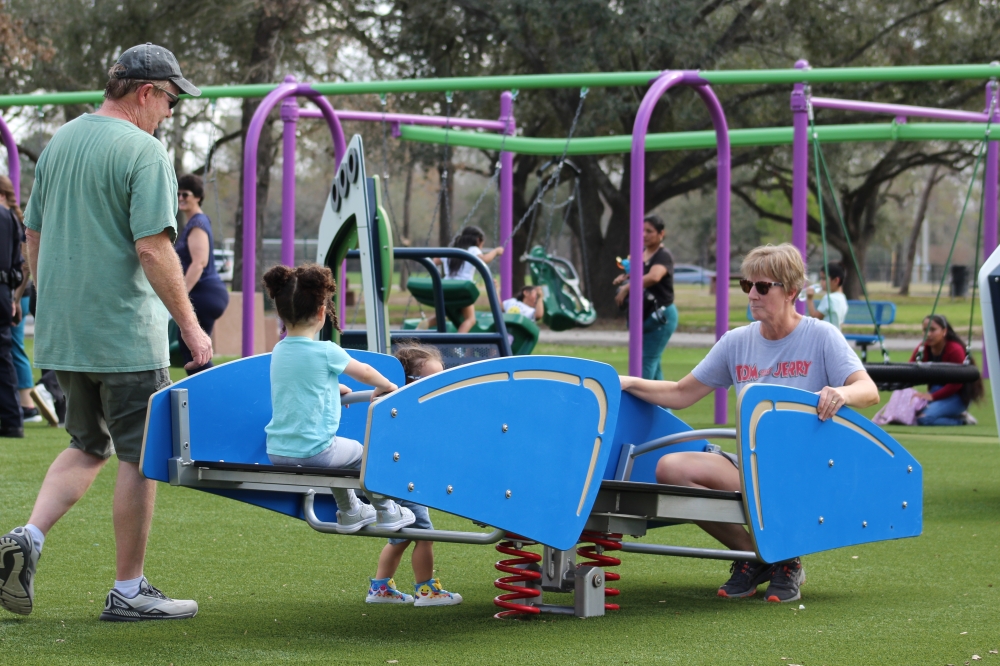 Families play at the new inclusive playground at Meyer Park in Spring. (Danica Lloyd/Community Impact)