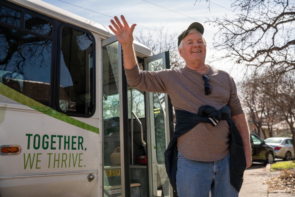 Senior day car in Austin participant waves