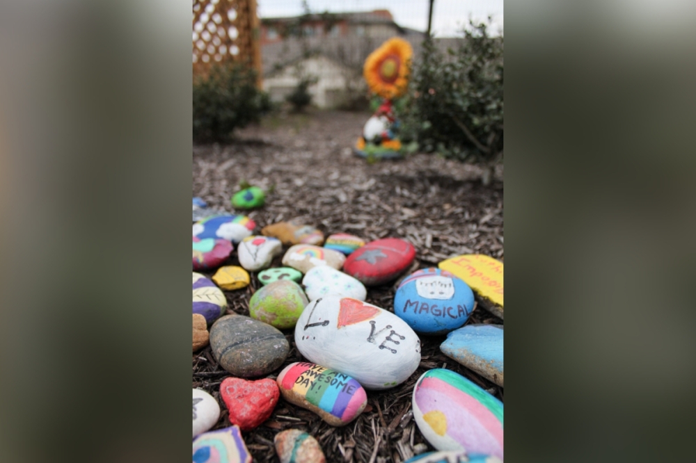 In the AGE of Central Texas Thrive Social and Wellness Center garden are painted rocks, painted by volunteer organization Austin Allies. Austin Allies shares the South Austin building with AGE of Central Texas and moved with AGE when they relocated from their downtown office in December 2024. (Elisabeth Jimenez/Community Impact)