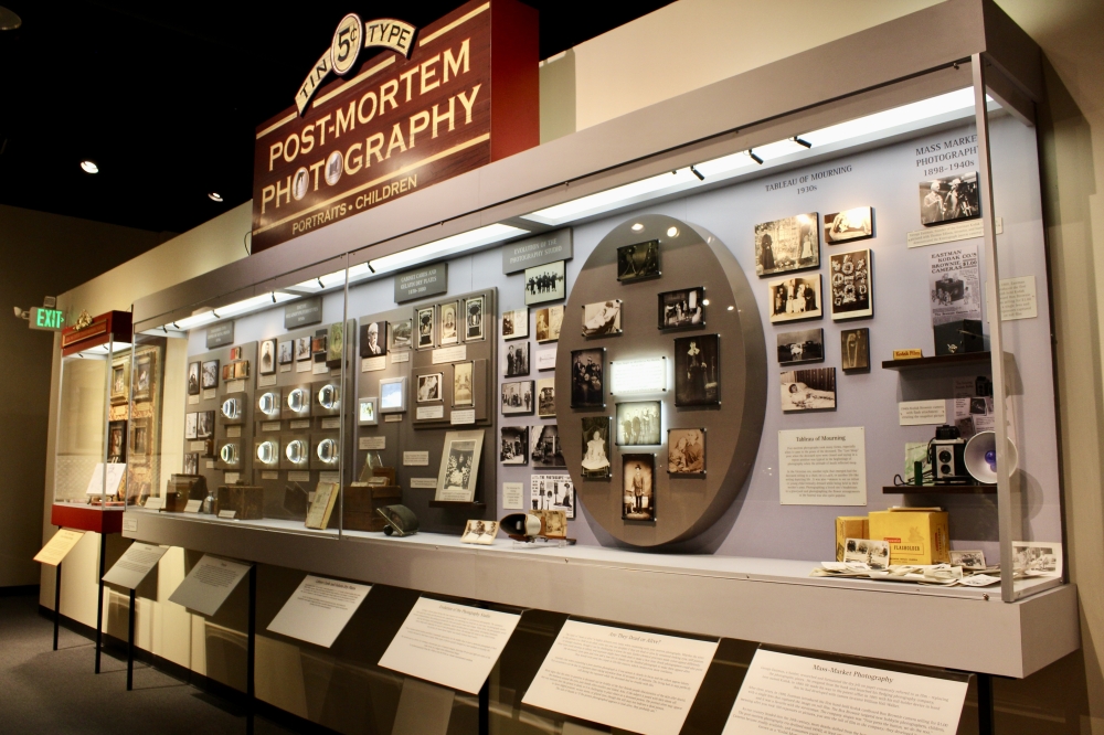 The Post-Mortem Photography wall features photos of the deceased, a funeral practice used amongst American and European cultures. (Jovanna Aguilar/Community Impact)